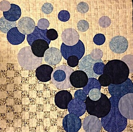 Quilted applique of blue shades of circles