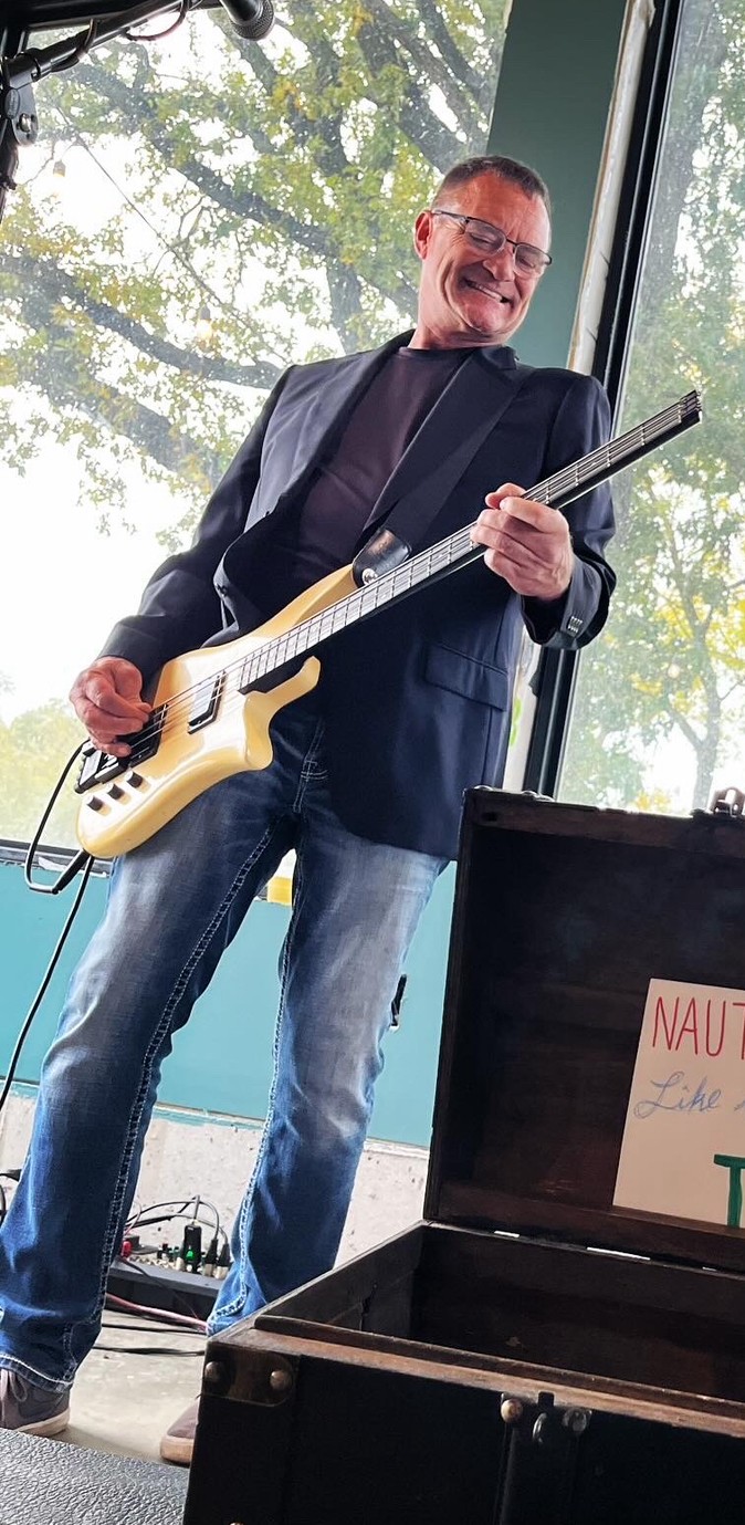 Tim playing a guitar on stage